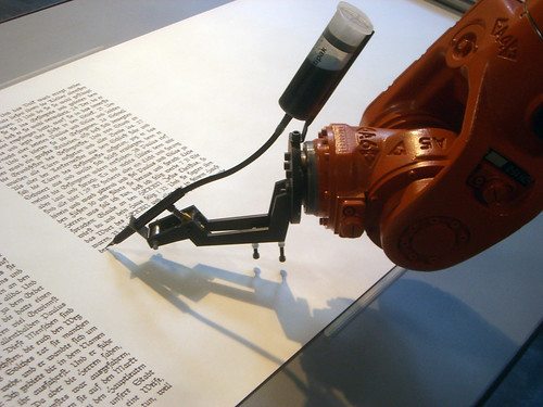 robot arm writing text in book