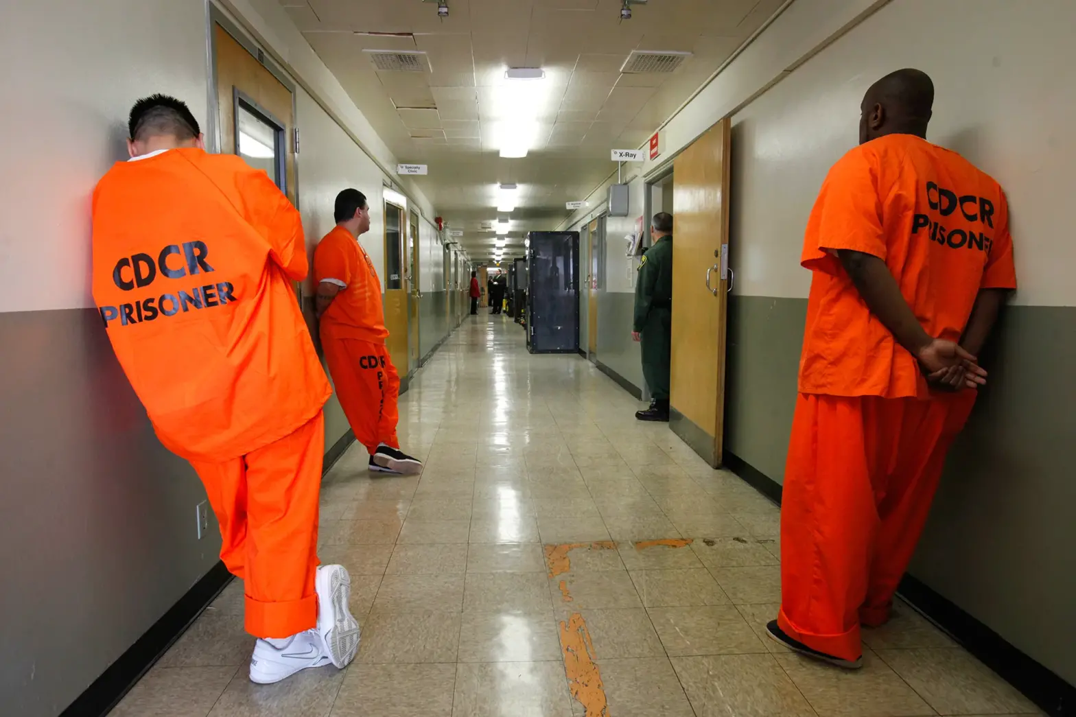 Prison Hallway Photo, Inmates Looking Away from Camera
